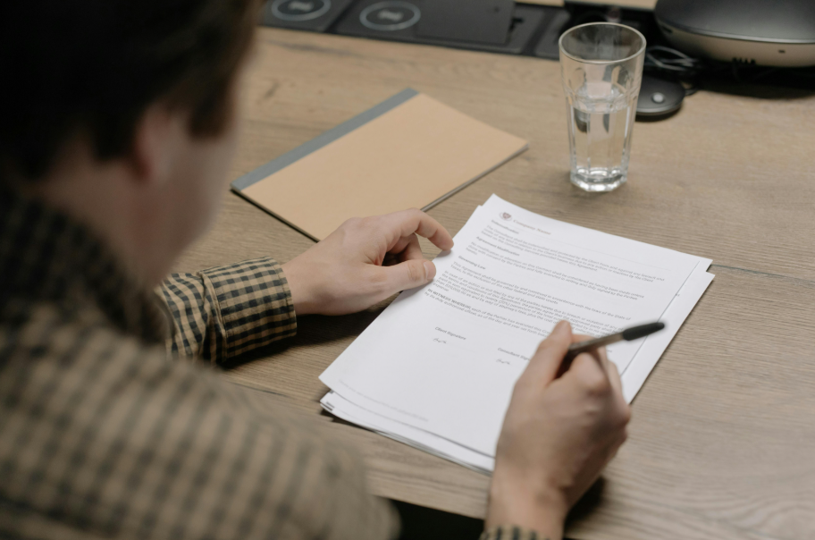 a man writing on a piece of paper